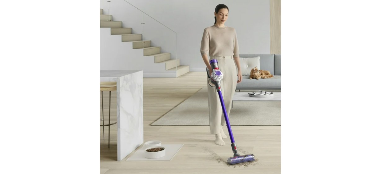 Woman using Dyson V8 Origin+ Cordless Vacuum on hard flooring