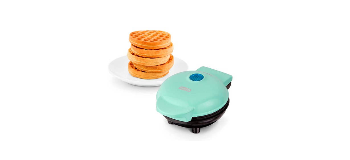 An aqua mini waffle maker with a stack of mini waffles on a plate next to it