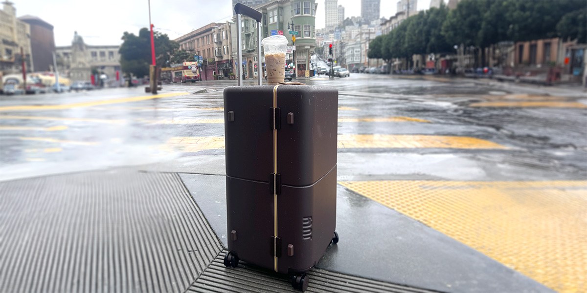 July Checked Trunk on road on rainy day with cup of iced coffee on top July Checked Trunk on road on rainy day with cup of iced coffee on top