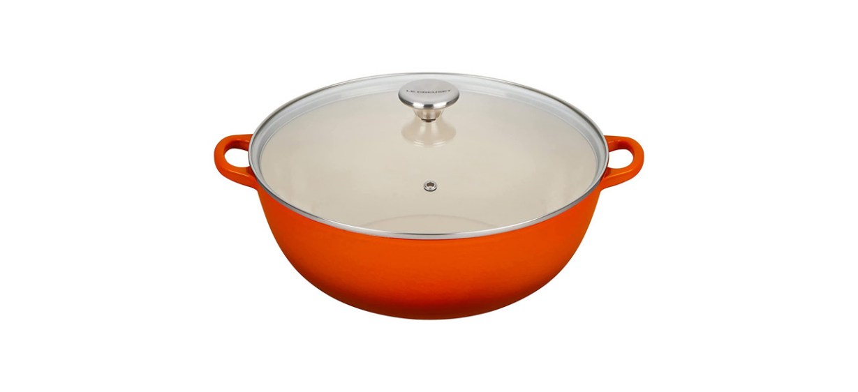 an orange cast-iron pot with a clear glass lid