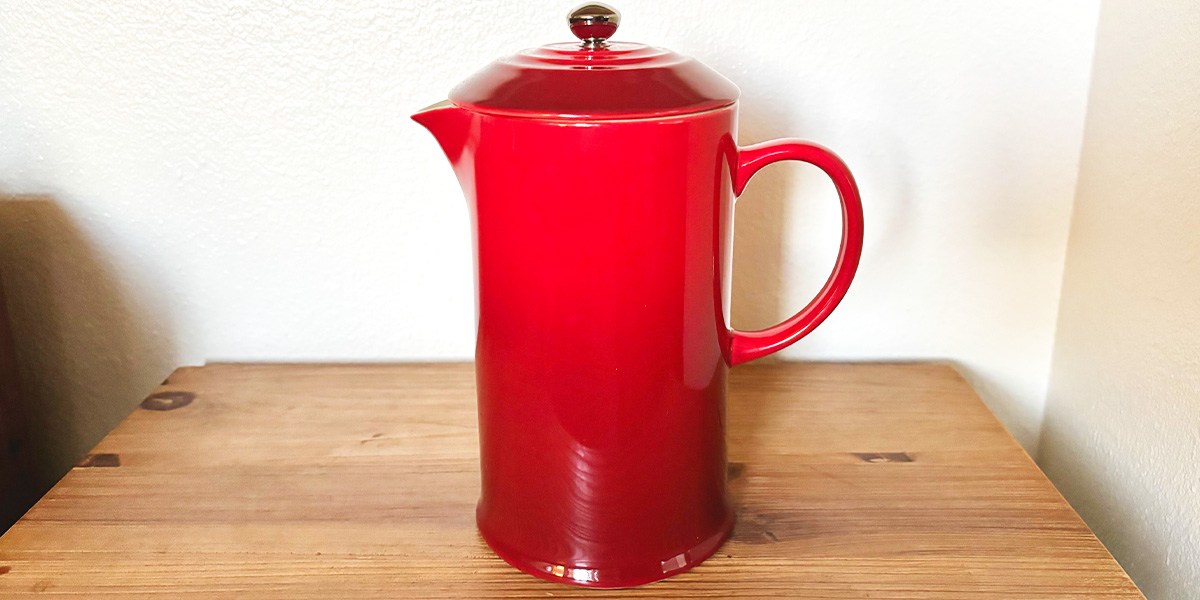 Red Le Creuset French Press on tabletop Red Le Creuset French Press on tabletop