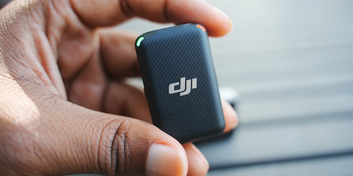 Hand holding DJI Mic with green light indicator on Hand holding DJI Mic with green light indicator on