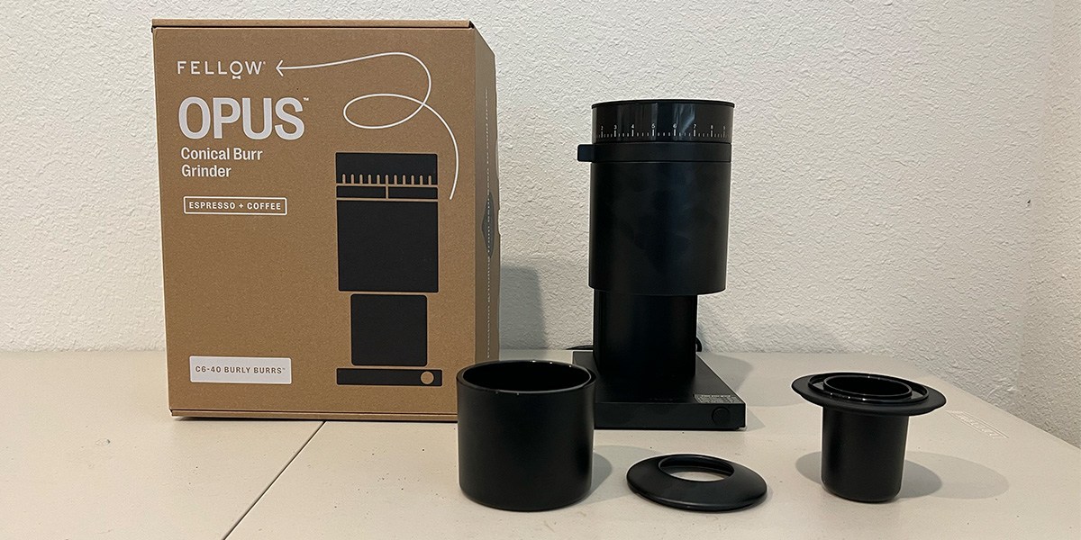 Coffee grinder on kitchen counter next to product packaging