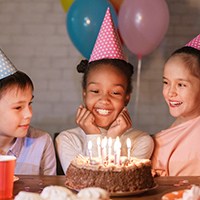 a young girl about to blow the birthday candles
