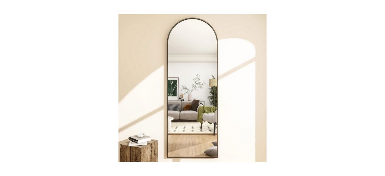 BEAUTYPEAK Arched Full-Length Floor Mirror hanging on a wall