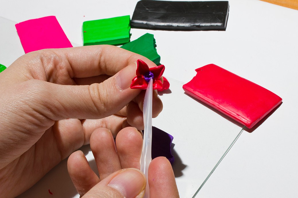 Hands working with polymer clay
