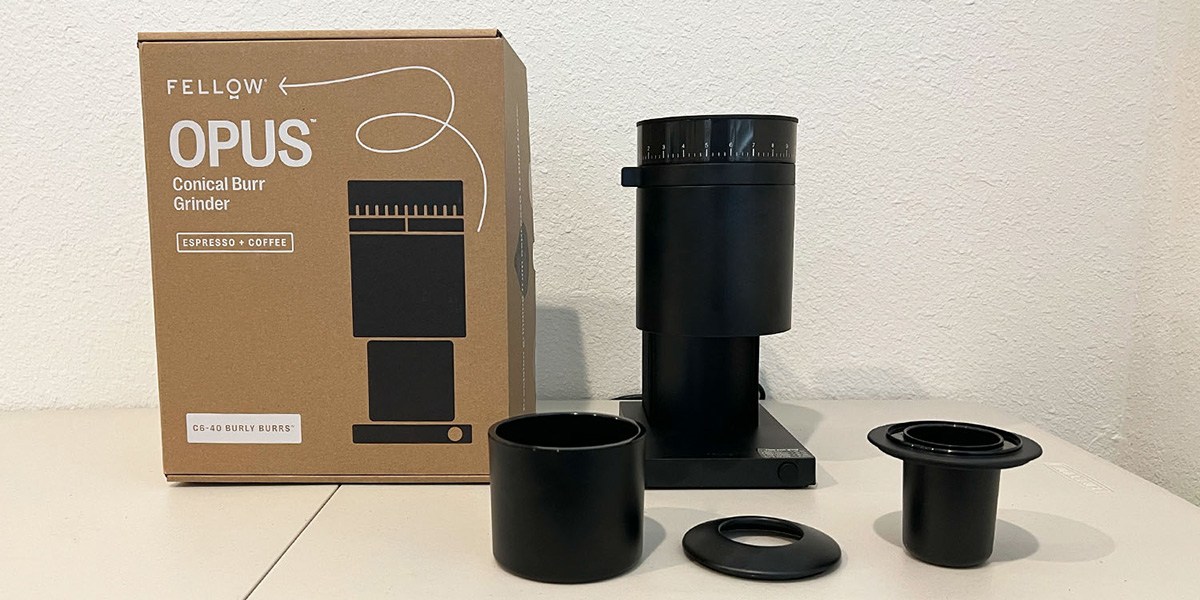 Fellow Opus Grinder on counter next to product packaging