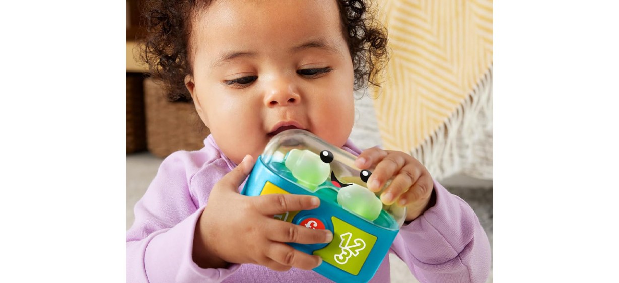 Toddler playing with Fisher-Price Laugh &amp; Learn Baby &amp; Toddler Toy Play Along Ear Buds
