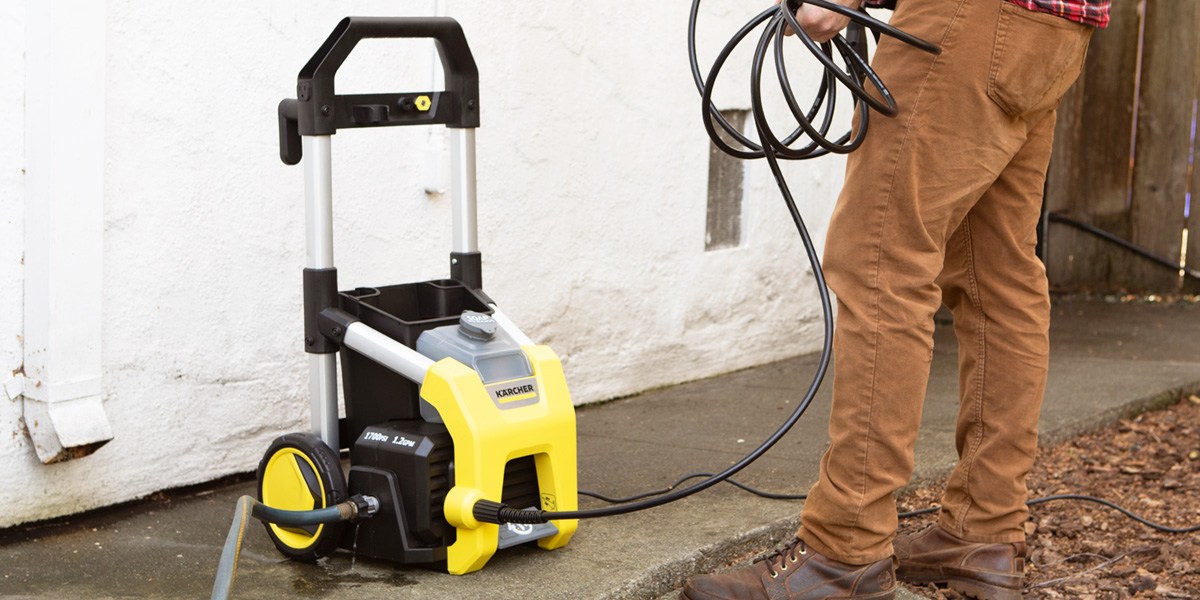 Kärcher K1700 Pressure Washer on sidewalk with person holding hose