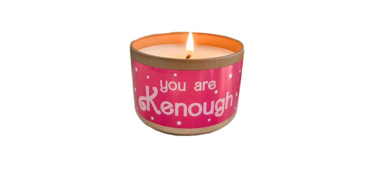 small white vanilla scented candle in pink tin that says &quot;you are kenough&quot;